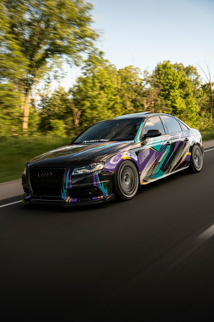 A sleek and colorful sports car speeding on a scenic road in Toronto, Canada.