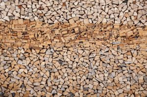 A large and organized stack of chopped firewood arranged neatly for winter heating needs.