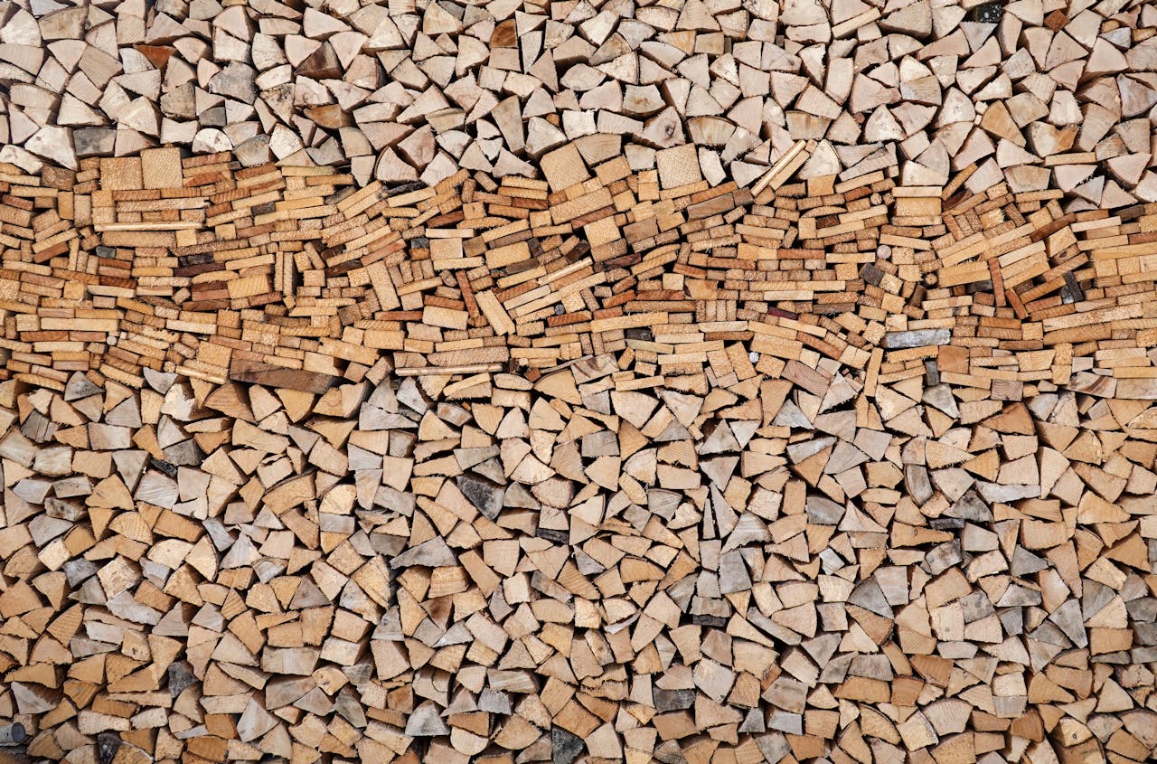 A large and organized stack of chopped firewood arranged neatly for winter heating needs.